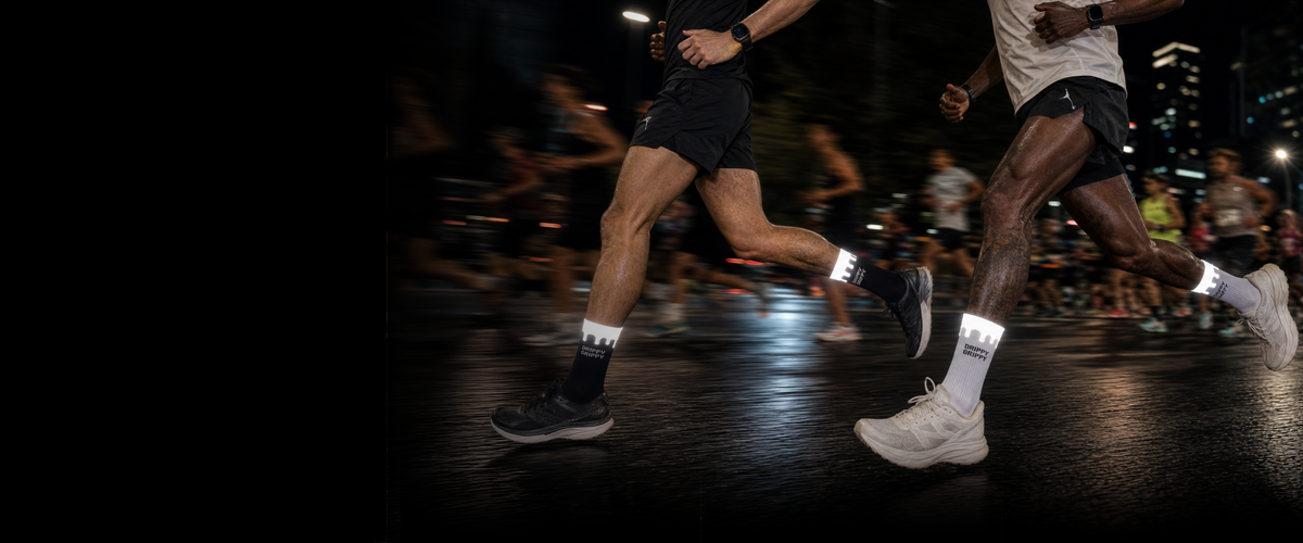 White and black Endurance grip socks with a reflective drip