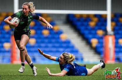 female Rugby player in Drippy Grippy grip socks running past another player. in stadium