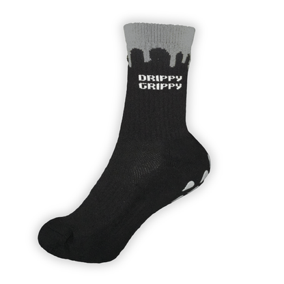 Reflective Black | A single black crew sock with a gray ribbed cuff featuring the words 'DRIPPY GRIPPY' in white on the side.